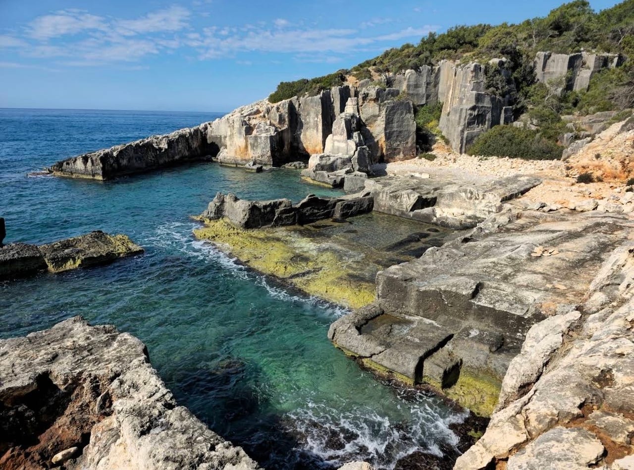 The ancient quarry at Demre — cut faces running down into the sea and blocks never lifted from their beds